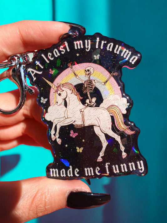 Funny Holographic black keychain charm with unicorn, skeleton, and curved text, metal ring clip