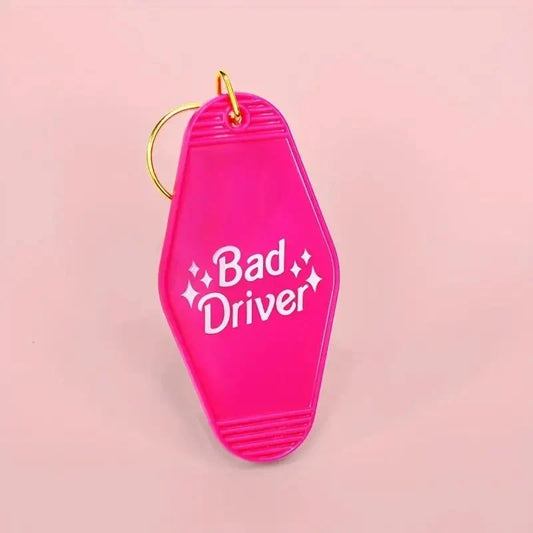 Funny Pink Bad Driver motel-style keychain tag with gold ring and hook