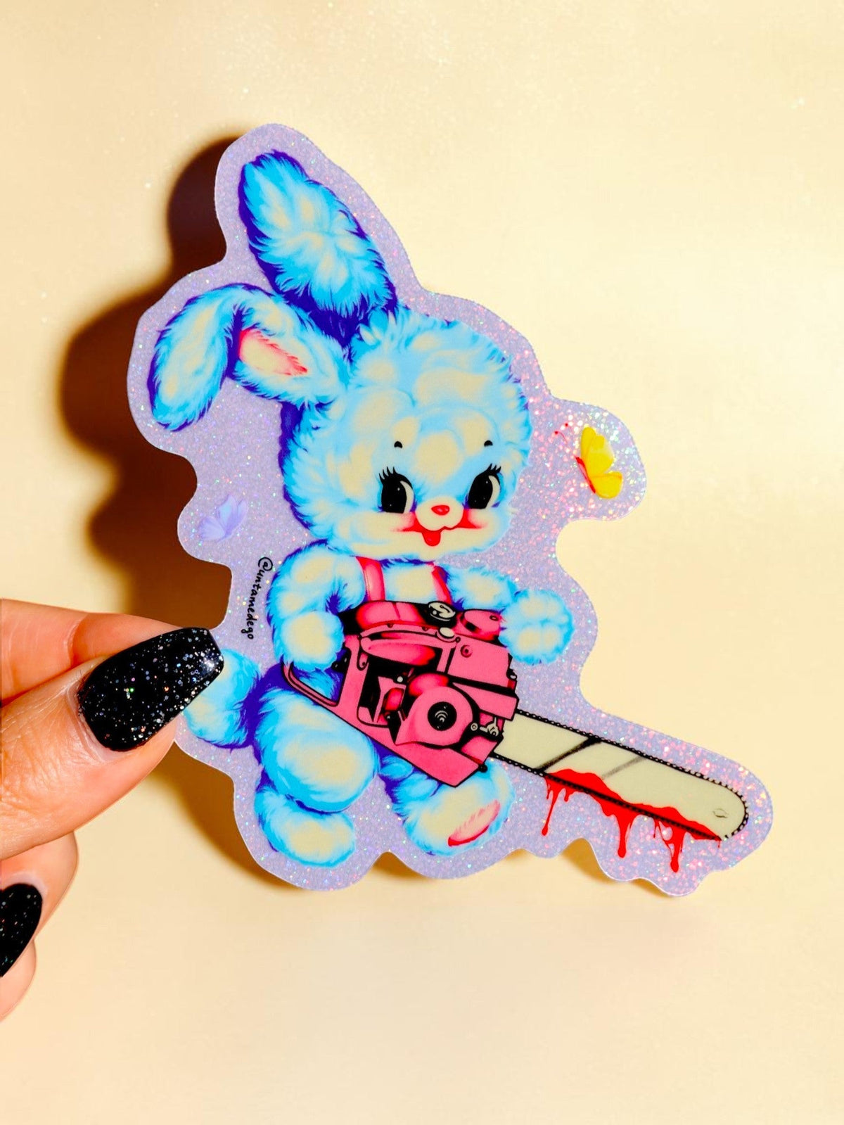 Funny Holographic bunny sticker holding a red chainsaw, cartoon pose with ears and paws up