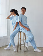 Elevated Faith Christian Apparel T-Shirt in light blue worn by male and female models seated on a stool