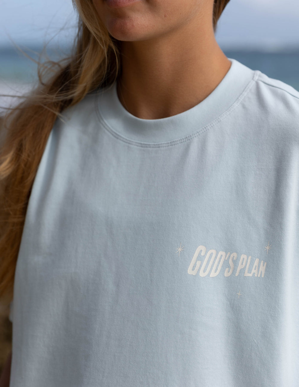 Elevated Faith Christian Apparel T-Shirt in light blue featuring 'GOD'S PLAN' graphic design