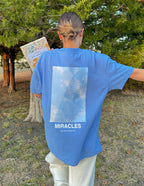 Elevated Faith Blue Christian Apparel T-Shirt with MIRACLES graphic on the back