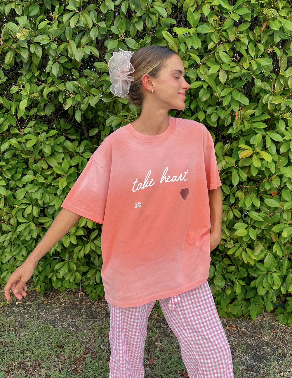 Elevated Faith Christian Apparel T-Shirt in soft pink with 'take heart' design and a heart symbol