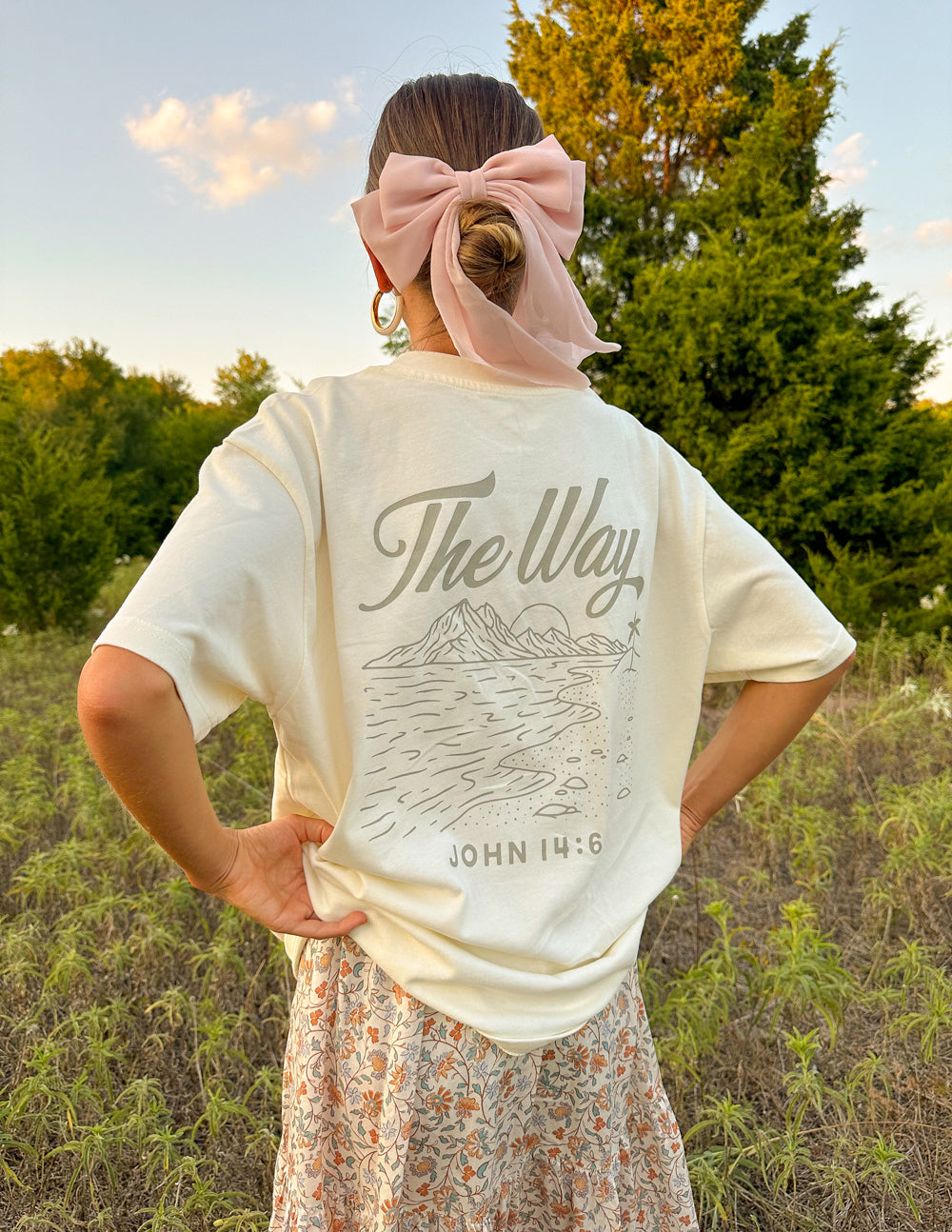 Elevated Faith Christian Apparel T-Shirt featuring uplifting design on the back in a natural setting
