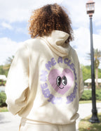 Elevated Faith Christian Hoodie in cream color with heart graphic and smiley face design on the back