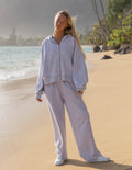Elevated Faith Christian Hoodie in soft lavender color, styled for a relaxed beach look