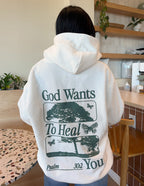 Elevated Faith Christian Hoodie featuring uplifting message 'God Wants To Heal You' and nature-inspired design