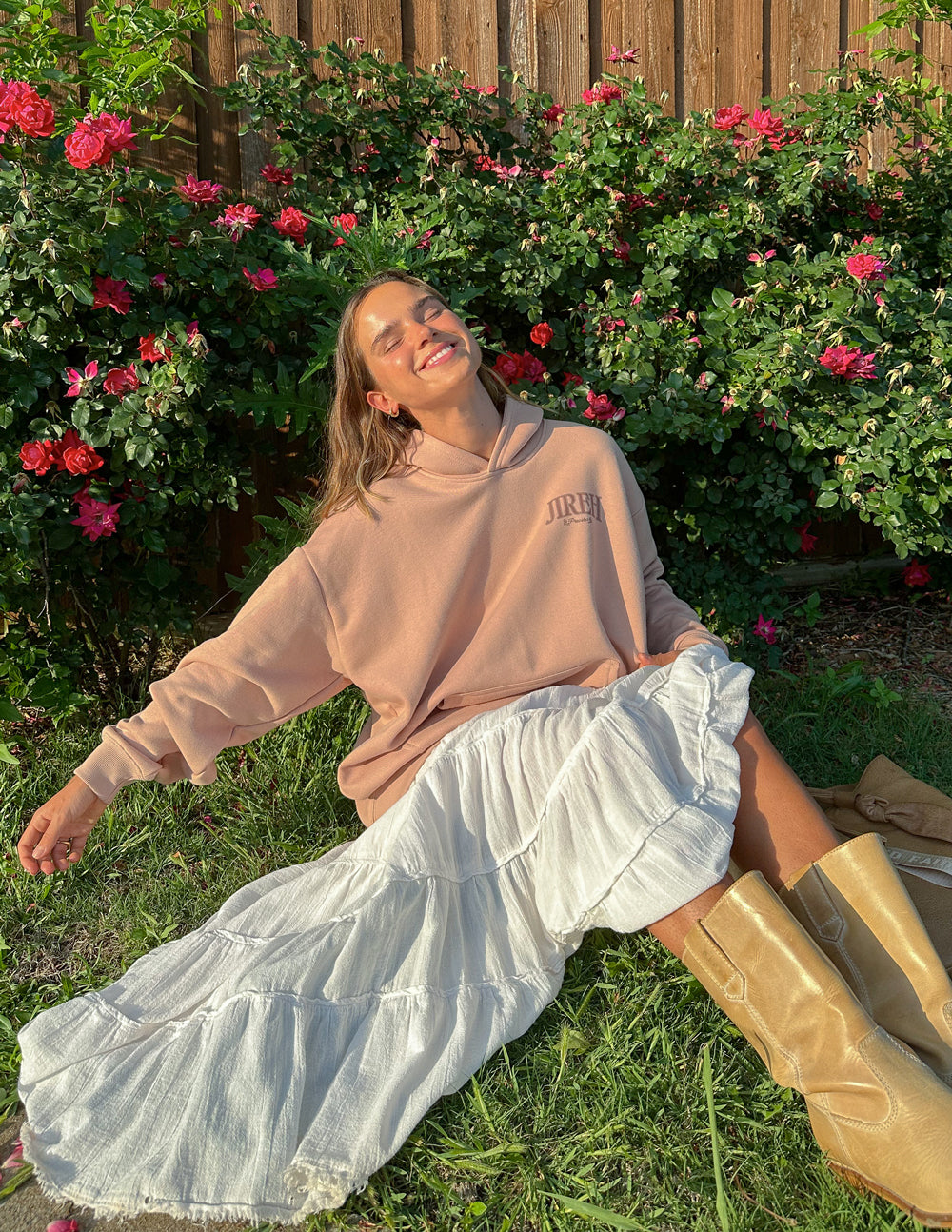 Elevated Faith Christian Hoodie in soft pink, styled with a flowing white skirt for a casual look