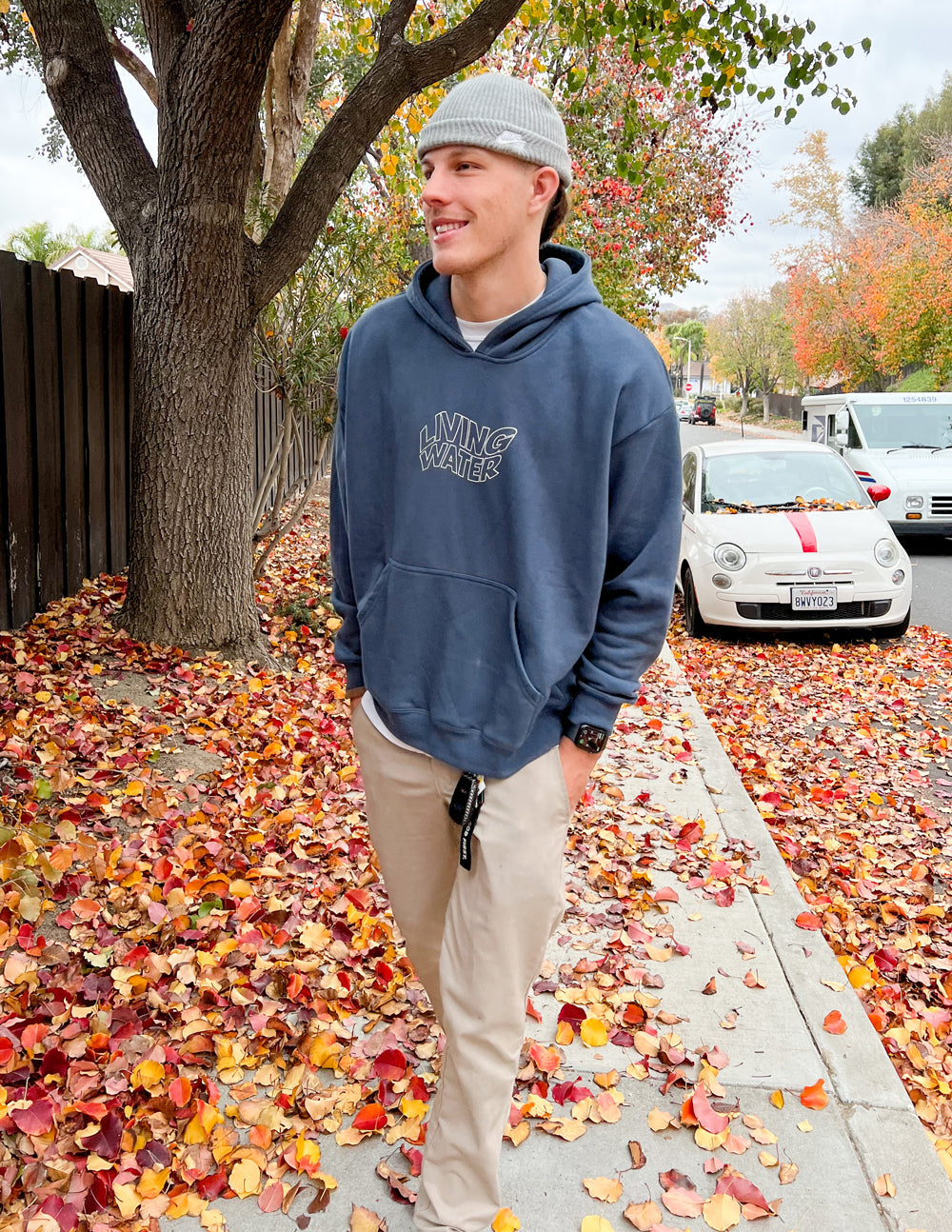 Elevated Faith Christian Hoodie in navy worn casually outdoors during autumn with colorful leaves