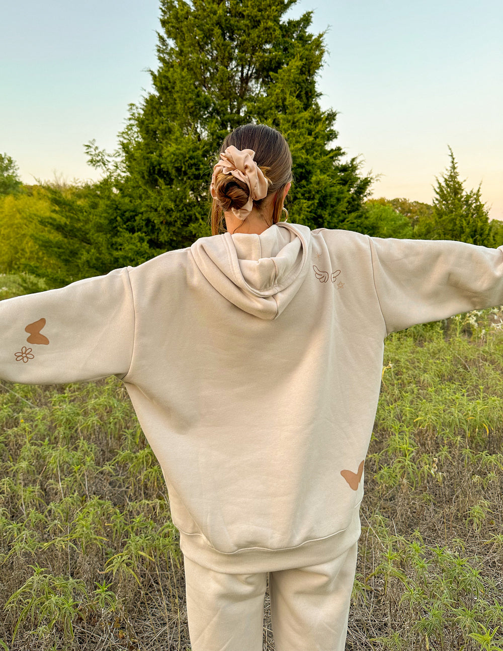 Elevated Faith Christian Hoodie in beige with butterfly accents and a relaxed fit for comfortable wear