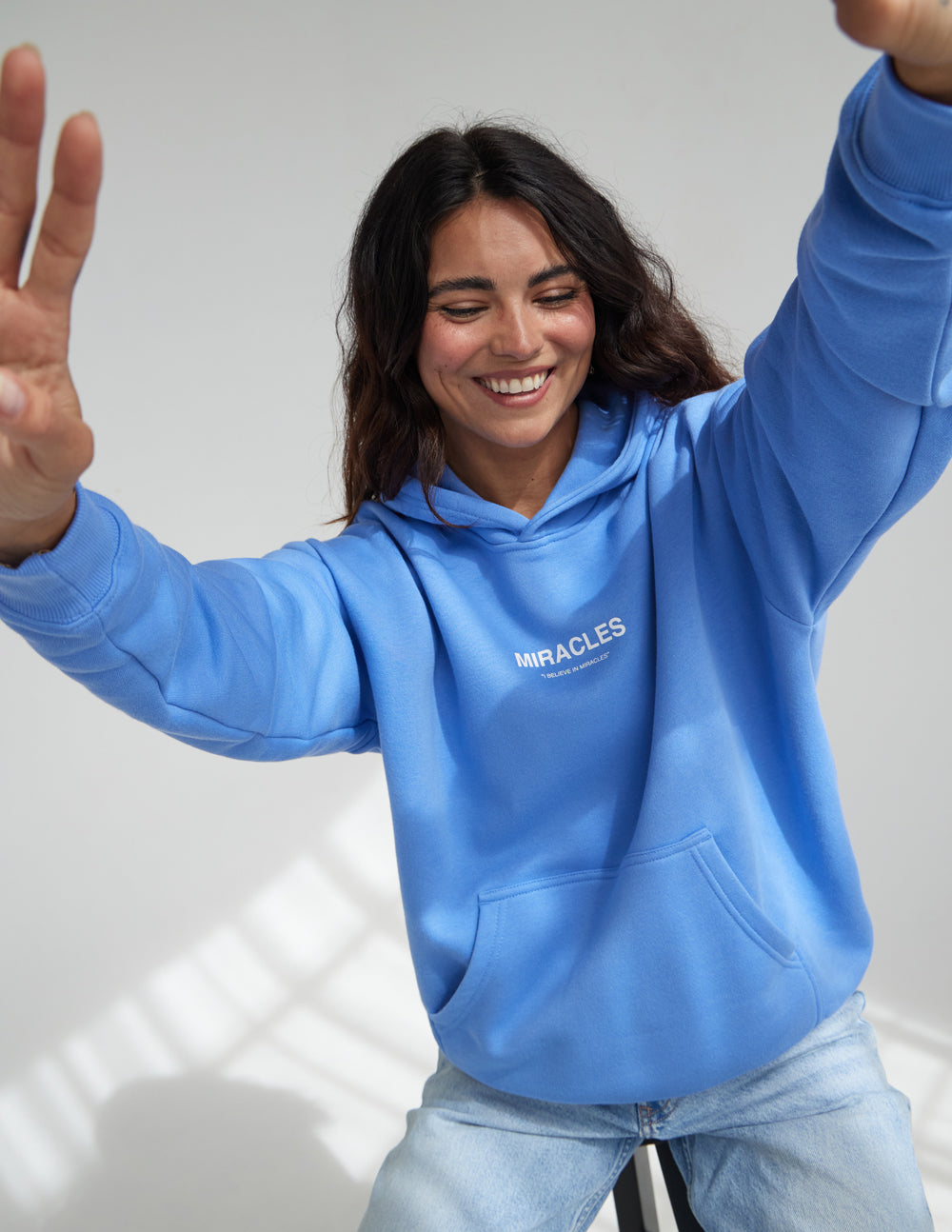 Elevated Faith Christian Hoodie in Blue with Miracles printed on the front, perfect for casual wear