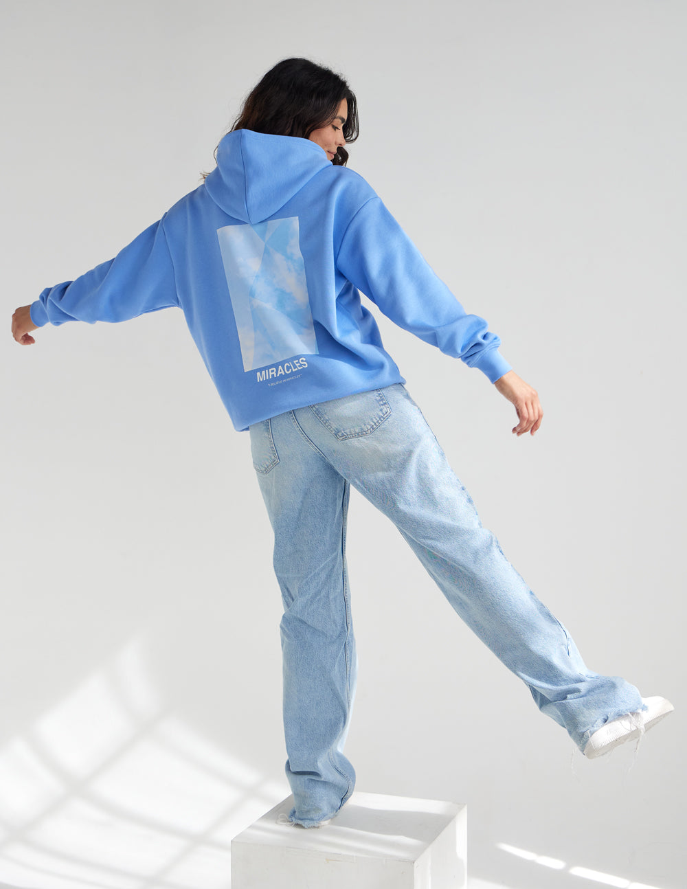 Blue Christian Hoodie by Elevated Faith featuring a stylish miracle graphic on the back