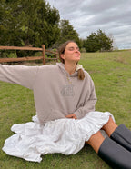Elevated Faith Christian Hoodie in beige with 'Spirit of God' print, worn in a natural outdoor setting