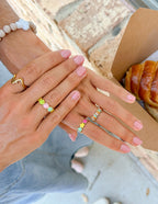 Two hands showcasing colorful Christian Jewelry rings from Elevated Faith, perfect for everyday wear