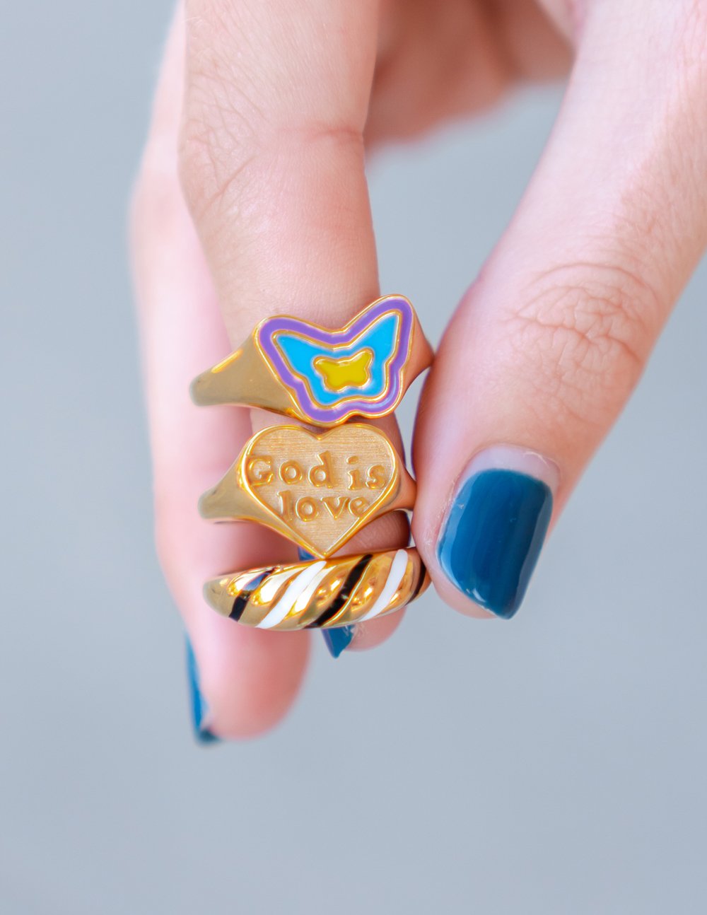 Three Stackable Rings from Elevated Faith featuring colorful designs and inscriptions in Christian Jewelry