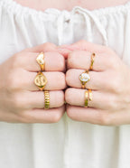 Set of Elevated Faith Christian Jewelry rings featuring various designs and gold plating on fingers