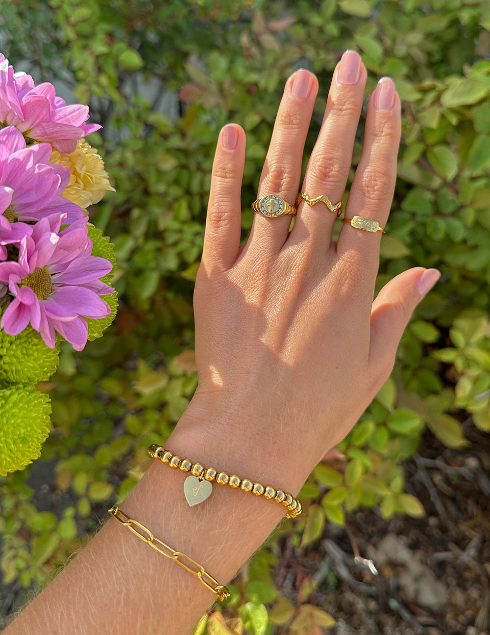 Elegant Elevated Faith Ring Set featuring Christian Jewelry displayed on a hand with colorful flowers