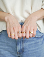 Stylish gold rings displayed on a woman's hands as elegant Christian Jewelry options