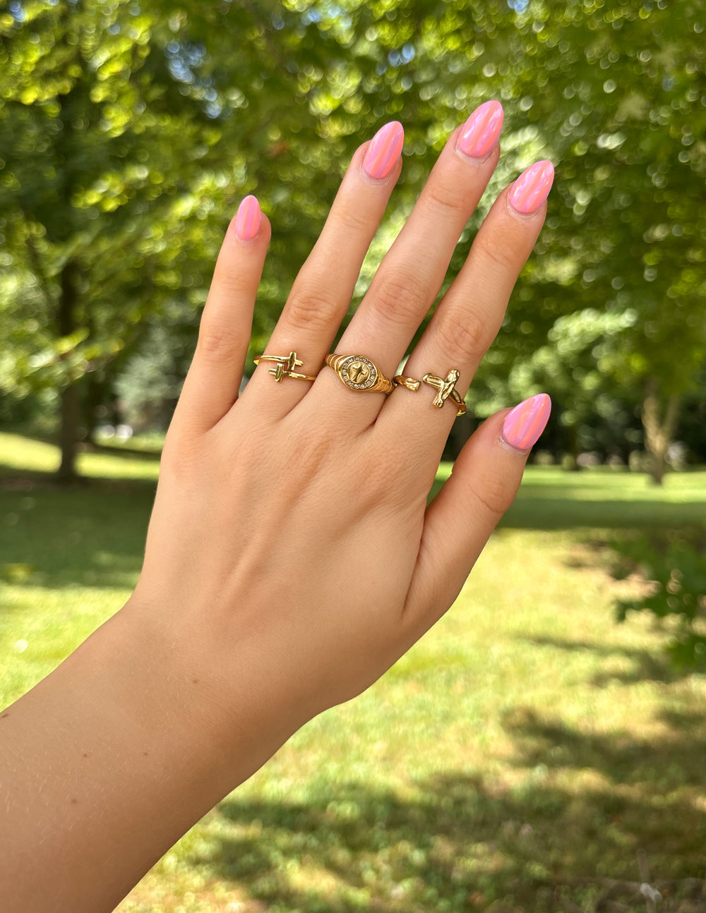 Elevated Faith Gold Ring Collection featuring Christian Jewelry and delicate cross designs on fingers