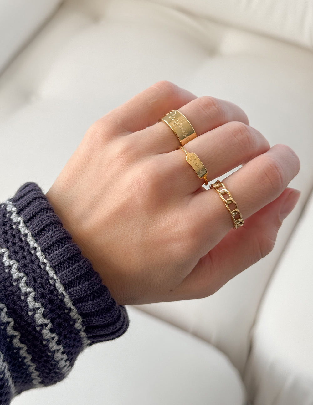 Elegant gold rings worn on hand, perfect for adding style to your Christian Jewelry collection
