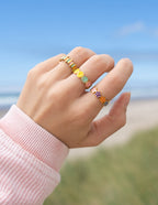 Stackable gold rings featuring colorful stones, perfect for Christian Jewelry enthusiasts