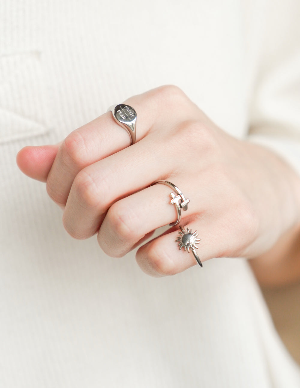 Elevated Faith Christian Jewelry featuring three unique silver rings for elegant faith-based styling
