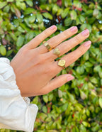 Elegant Elevated Faith Rings Collection showcasing Christian Jewelry on a hand against a green background