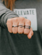 Elevated Faith Christian Jewelry ring stack featuring unique designs and a polished finish
