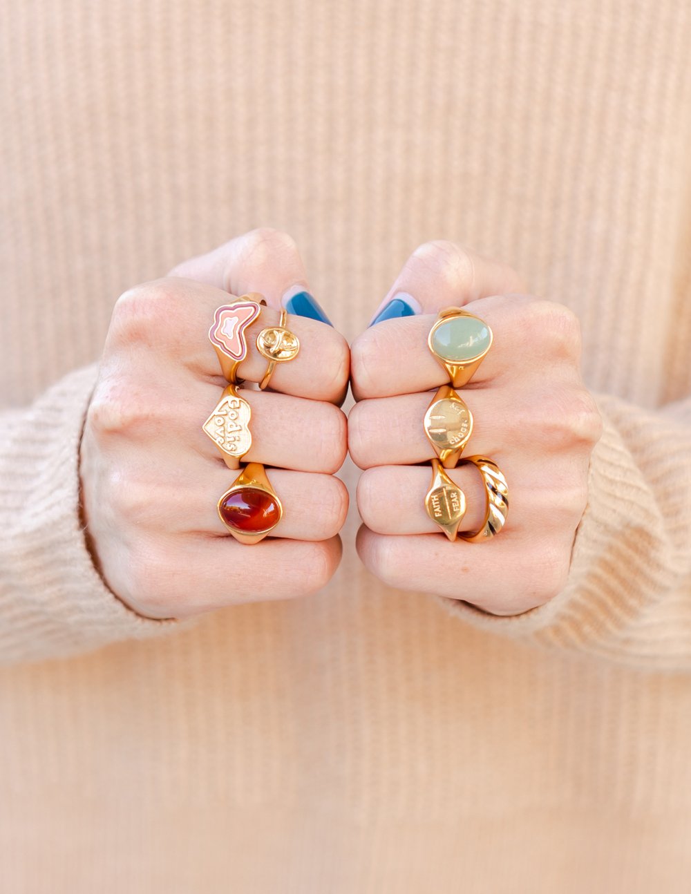 Collection of Elevated Faith Christian Jewelry Rings in various designs and colors on hands
