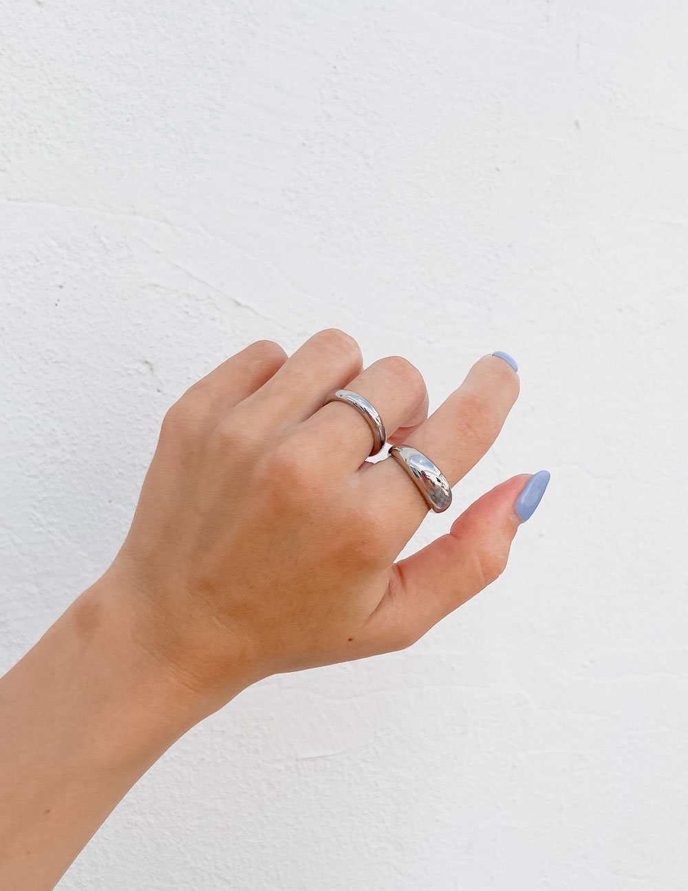 Elevated Faith Ring showing a hand wearing Christian Jewelry in a stylish design on a light background