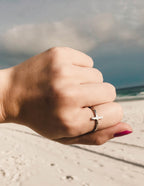 Elevated Faith Christian Jewelry Silver Ring with Cross Design Worn on Beach Hand