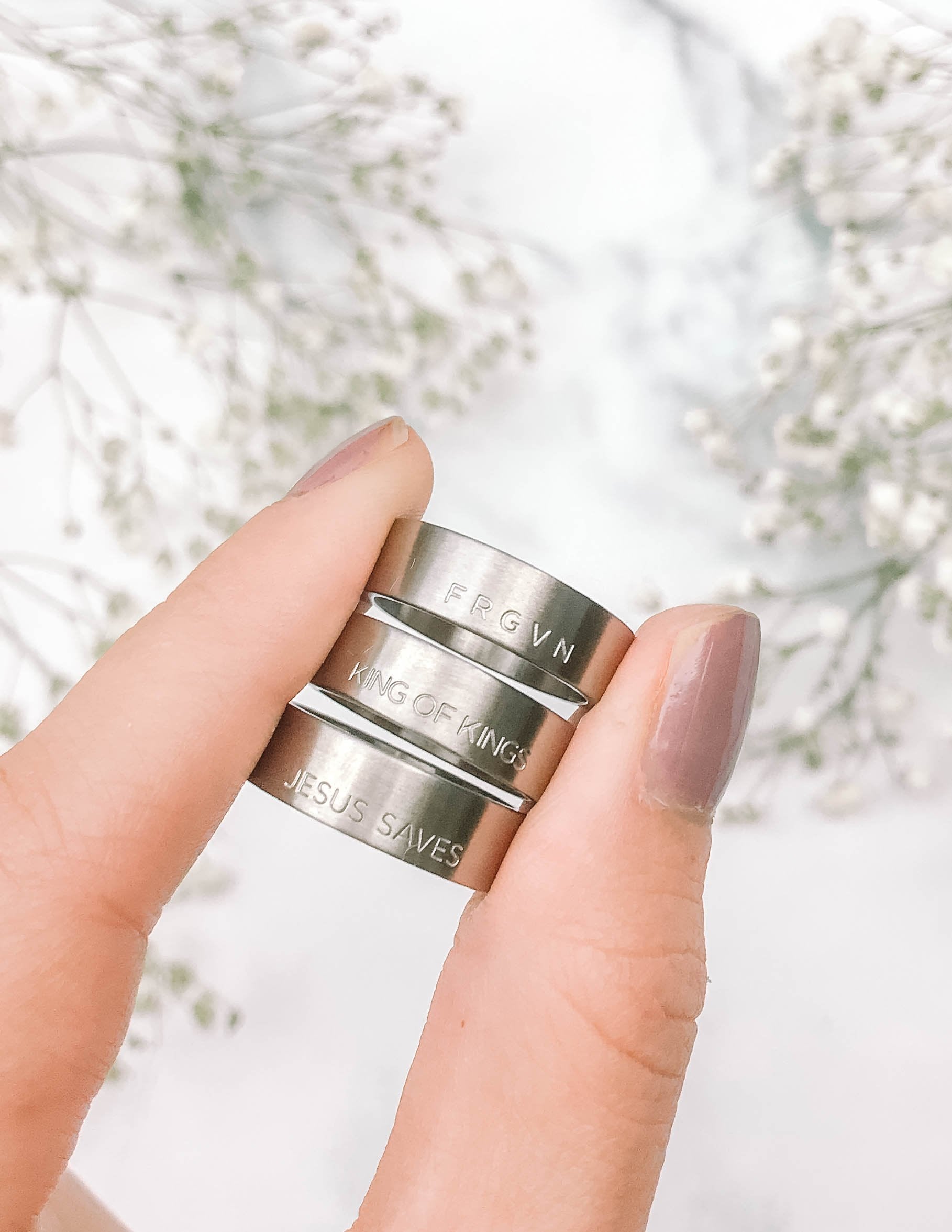 Stackable Christian Jewelry rings engraved with messages like King of Kings and Jesus Saves