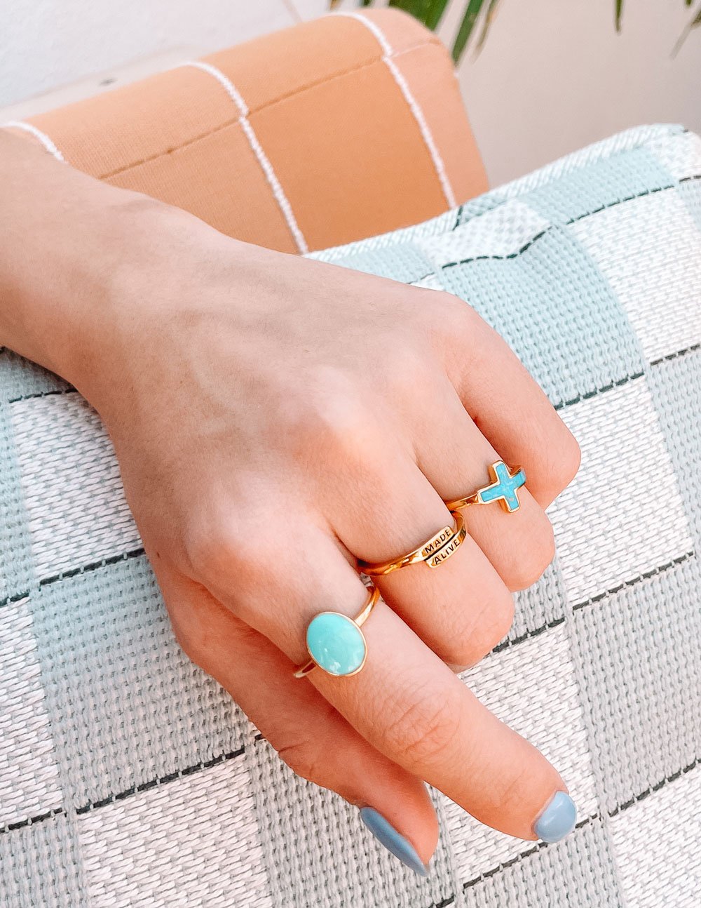 Elevated Faith Christian Jewelry Ring Set featuring gold cross and turquoise stones on hand