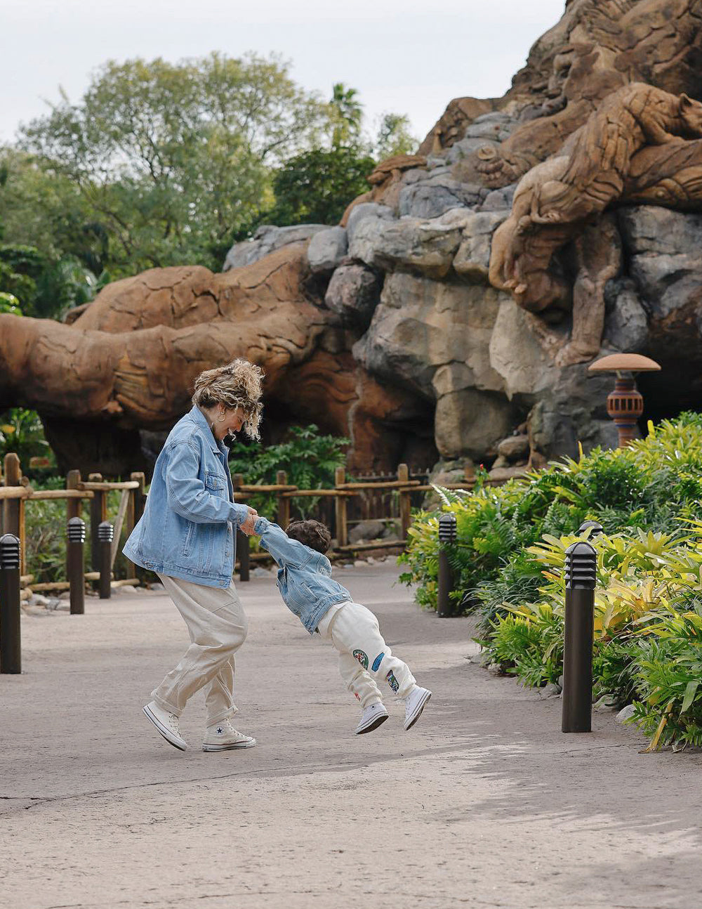 Child wearing a denim jacket from Elevated Faith while playing in the park, promoting Christian Kids Apparel