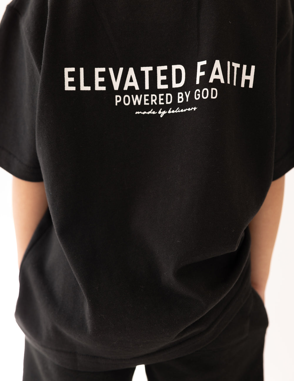 Black Elevated Faith Kids T-Shirt with 'Powered by God' design, perfect Christian Kids Apparel