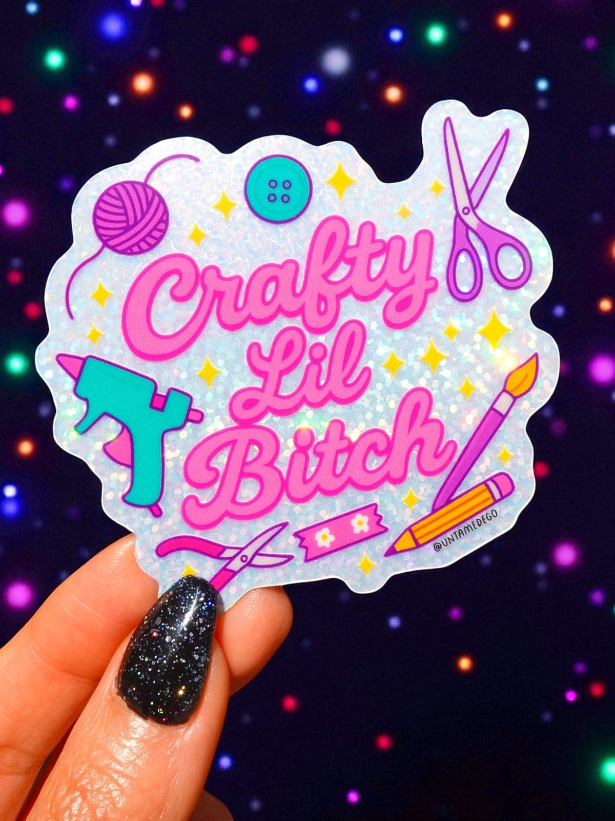 Funny Die-cut holographic craft sticker with pink “Crafty Lil Bitch” text, scissors and yarn.