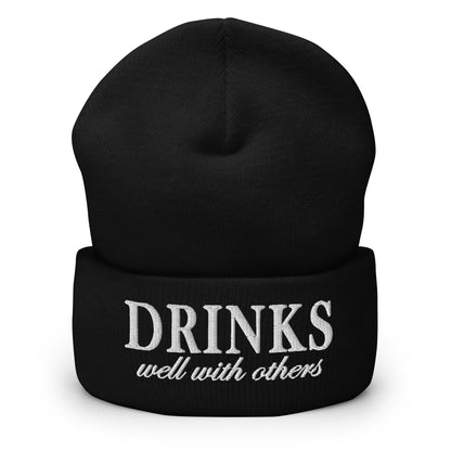 Black knit cuffed beanie with embroidered 'DRINKS' and 'well with others'