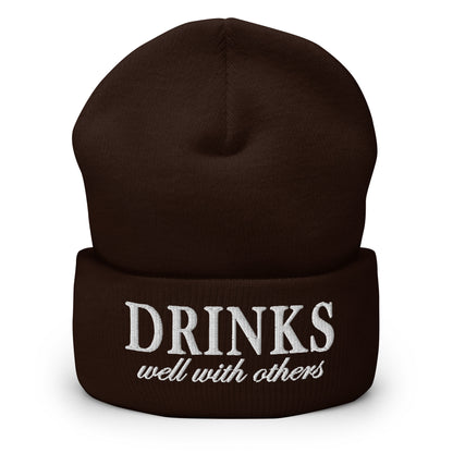 Brown knit cuffed beanie with embroidered 'DRINKS' and 'well with others'