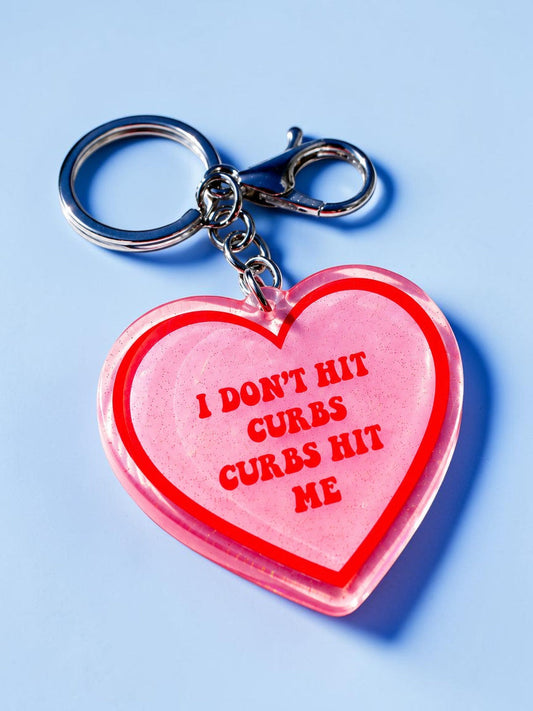 Funny Red holographic heart keychain with split ring and lobster clasp, glitter finish, 'I DON'T HIT CURBS'.