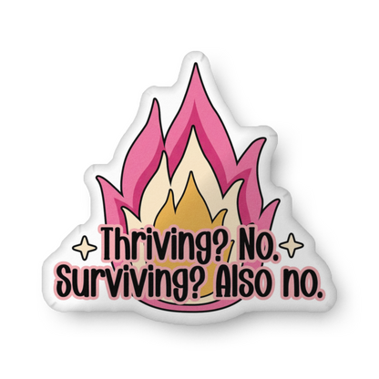 Custom-shaped pillow with pink flame graphic and 'Thriving? No, Surviving? Also no.'