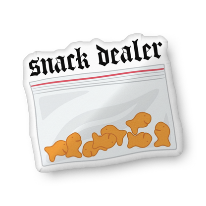 Custom-shaped snack-themed pillow in snack bag shape with “snack dealer” text and orange snacks