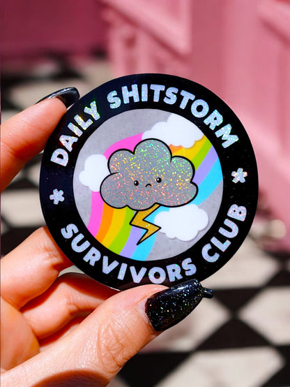 Funny Black round sticker with rainbow cloud and 'Daily SHITSTORM' lettering