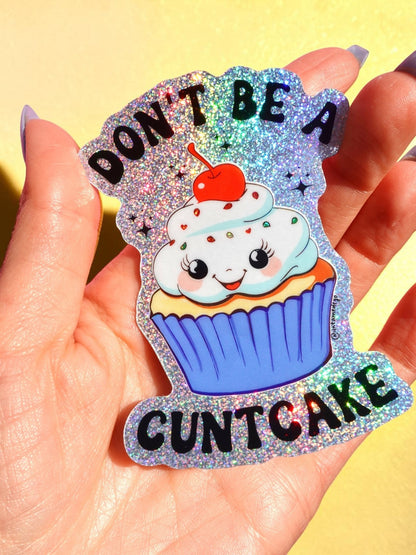 Funny Glitter cupcake cat sticker on hand, “DON’T BE A” and “CUNTCAKE” text