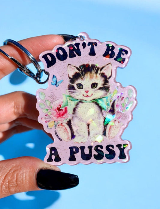 Funny Holographic cat keychain with 'DON'T BE' and 'A PUSSY' text, butterfly accents