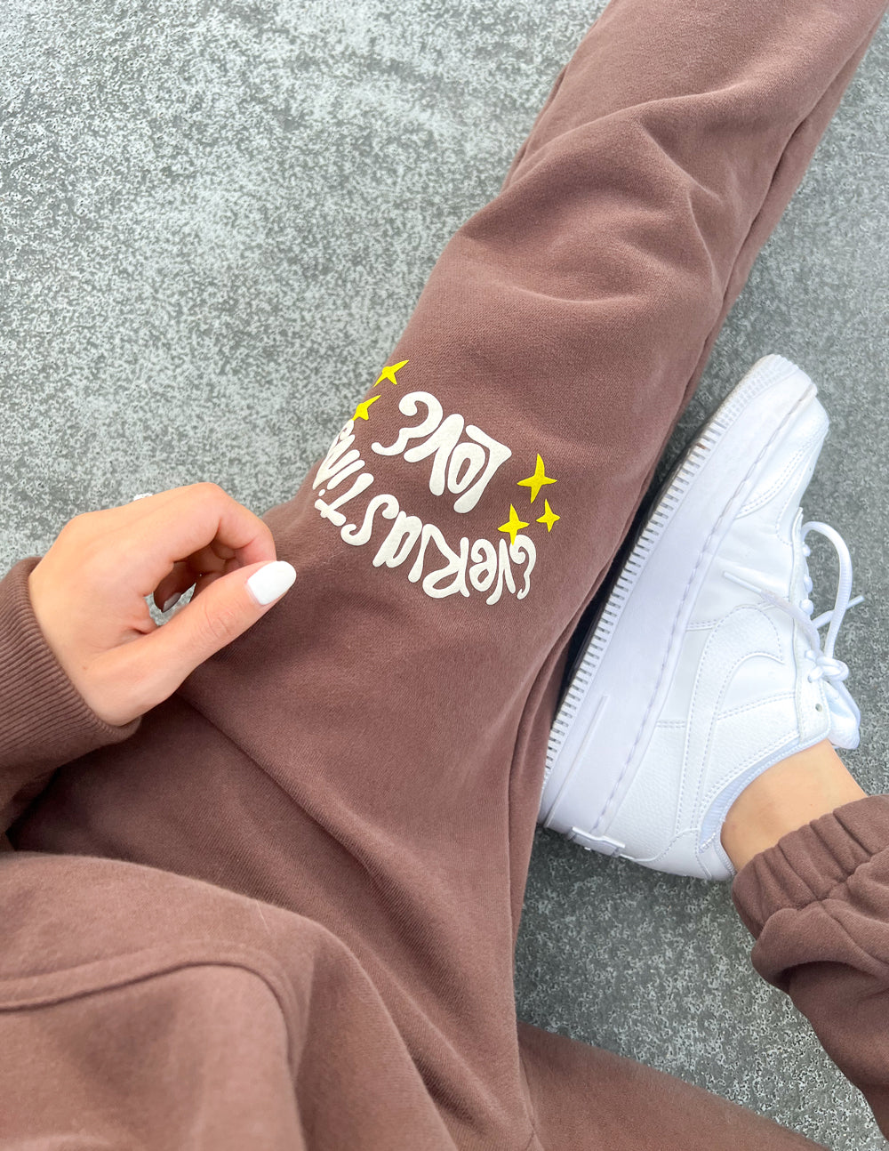 Brown Elevated Faith Sweatpants featuring playful 'Get Real' text, part of Christian Apparel collection