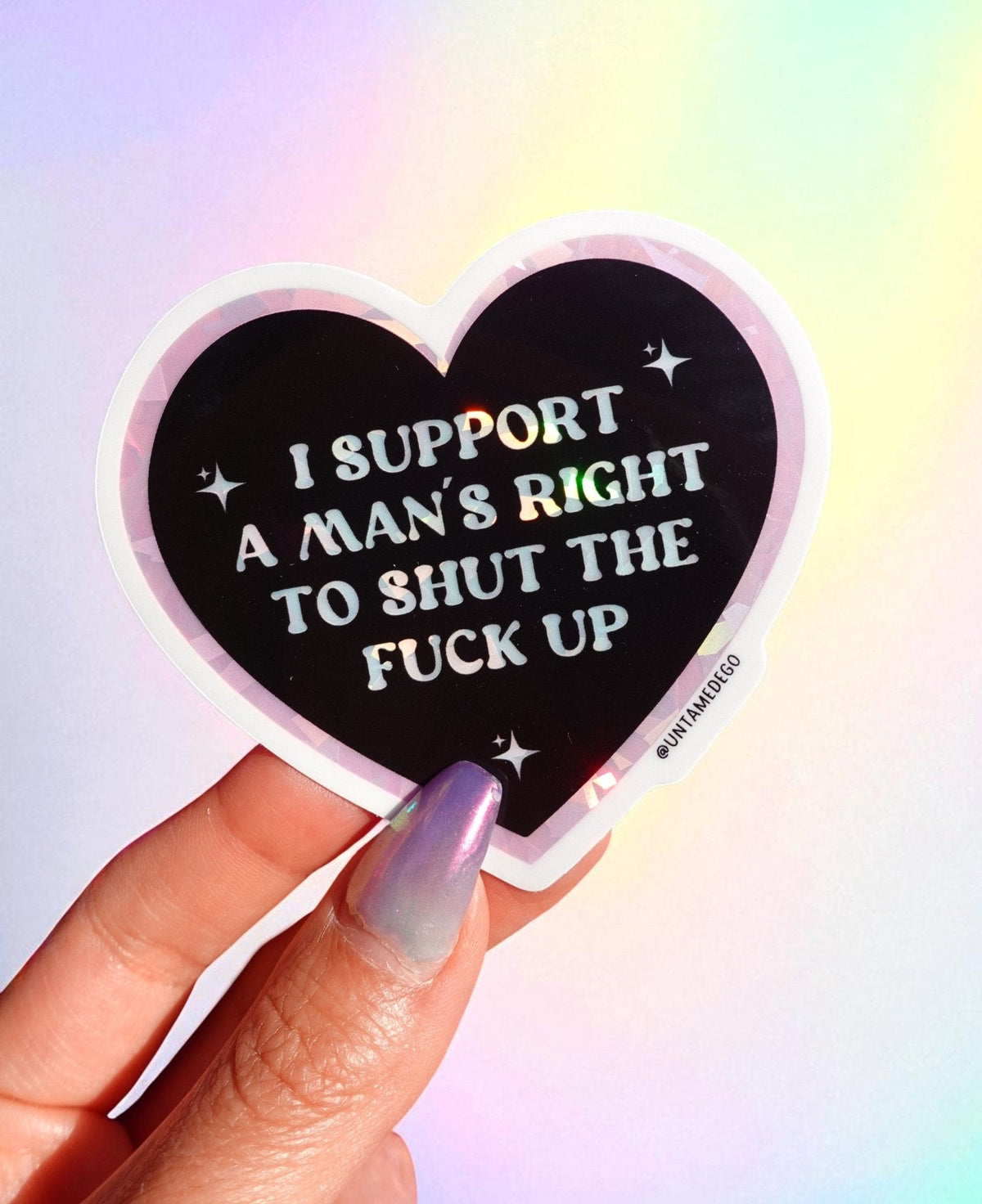 Funny Heart-shaped sticker with black background and white quote text, held by finger