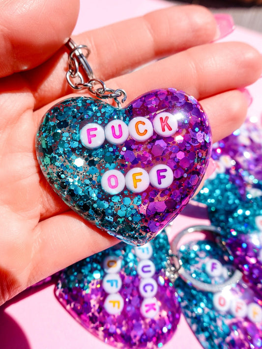 Funny Glitter heart keychain with metal ring and chain, teal-to-purple glitter “FUCK OFF”