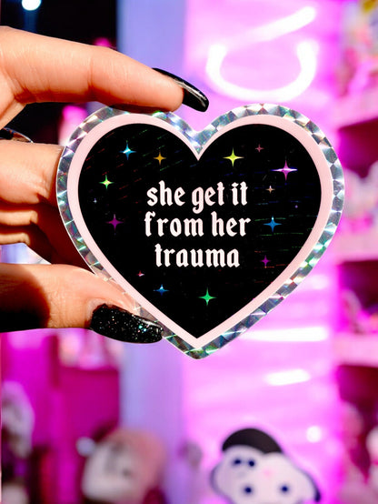 Funny Heart-shaped sticker with text “she get it from her trauma” and sparkles