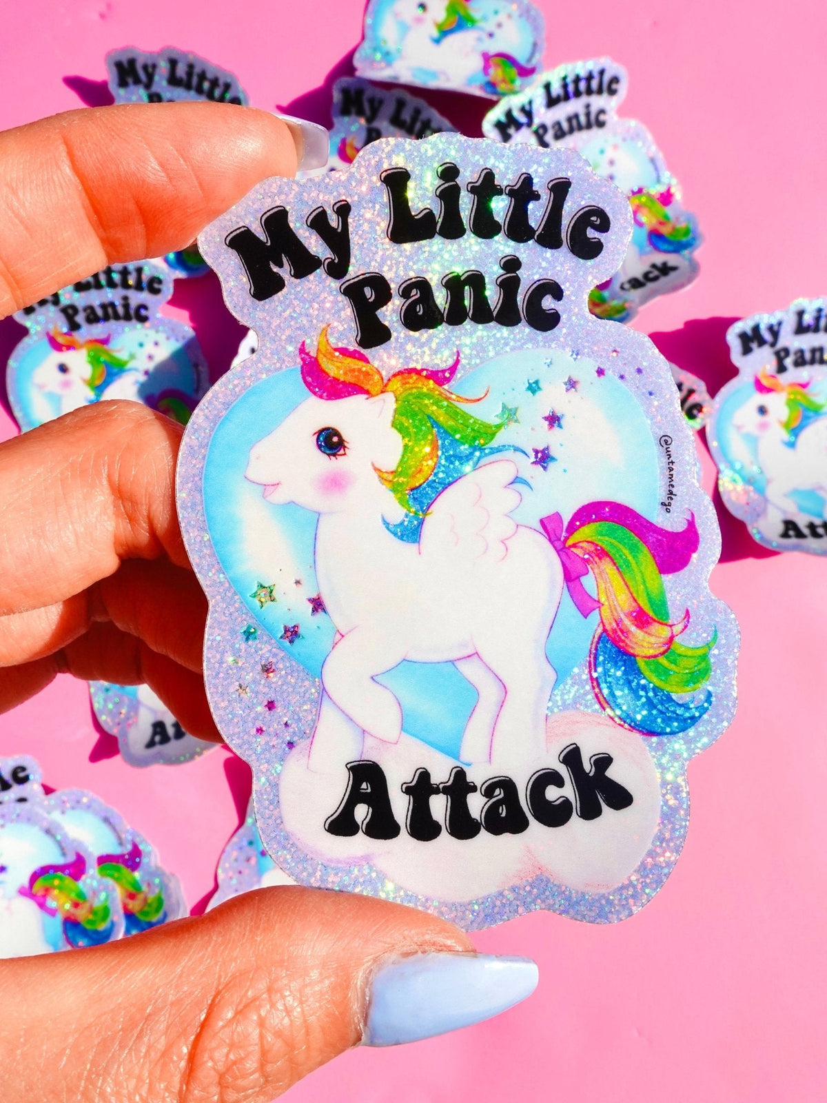 Funny Unicorn glitter sticker held in hand, rainbow mane and 'My Little Panic Attack' text.
