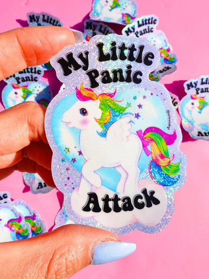 Funny Unicorn glitter sticker held in hand, rainbow mane and 'My Little Panic Attack' text.